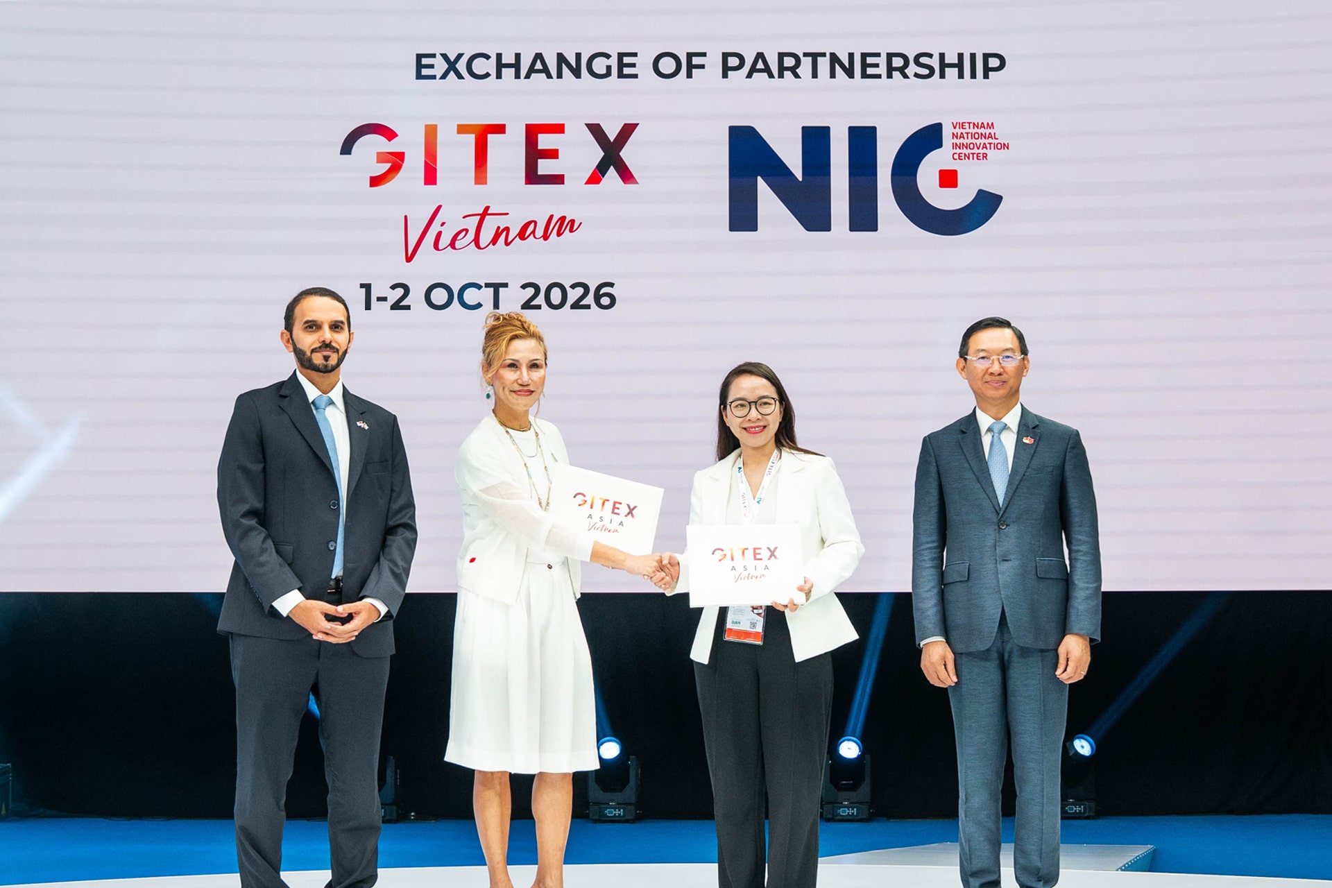 Photo depicts Kaoun International CEO Trixie LohMirmand shaking hands with Kim Ngoc Thanh Nga, deputy director of the Vietnam National Innovation Center, during a ceremony announcing GITEX Vietnam.