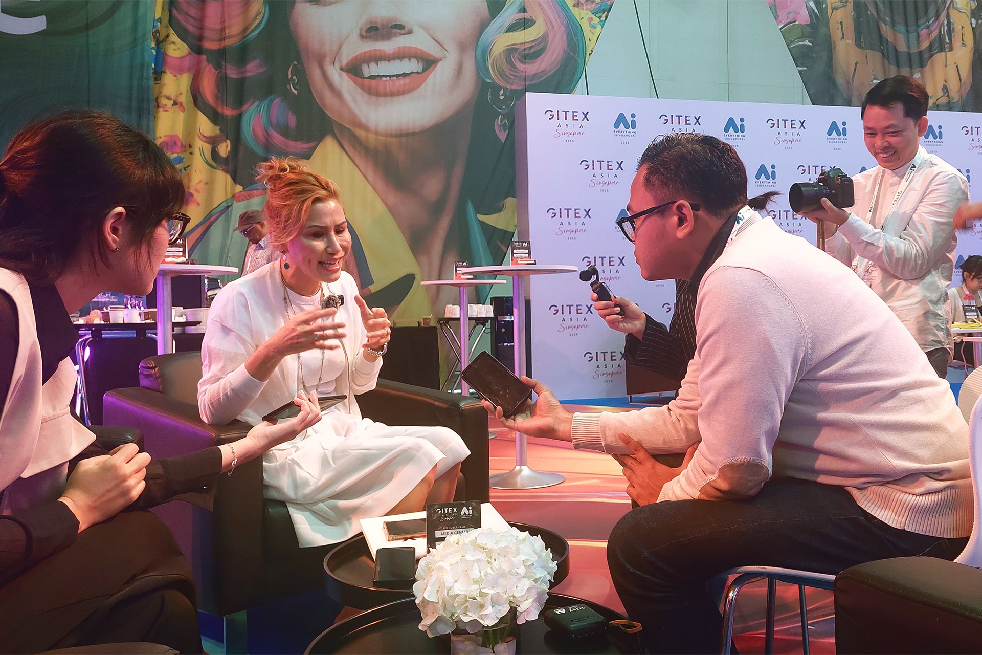 Photo of journalists from the international media delegation speaking with Trixie LohMirmand, CEO of Kaoun International and executive vice president of the Dubai World Trade Centre, during an interview coordinated by KrASIA.